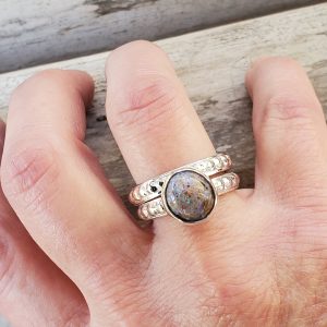 Round Louisiana Opal Cabochon Sterling Silver Textured Ring shown with second band on model's ring finger