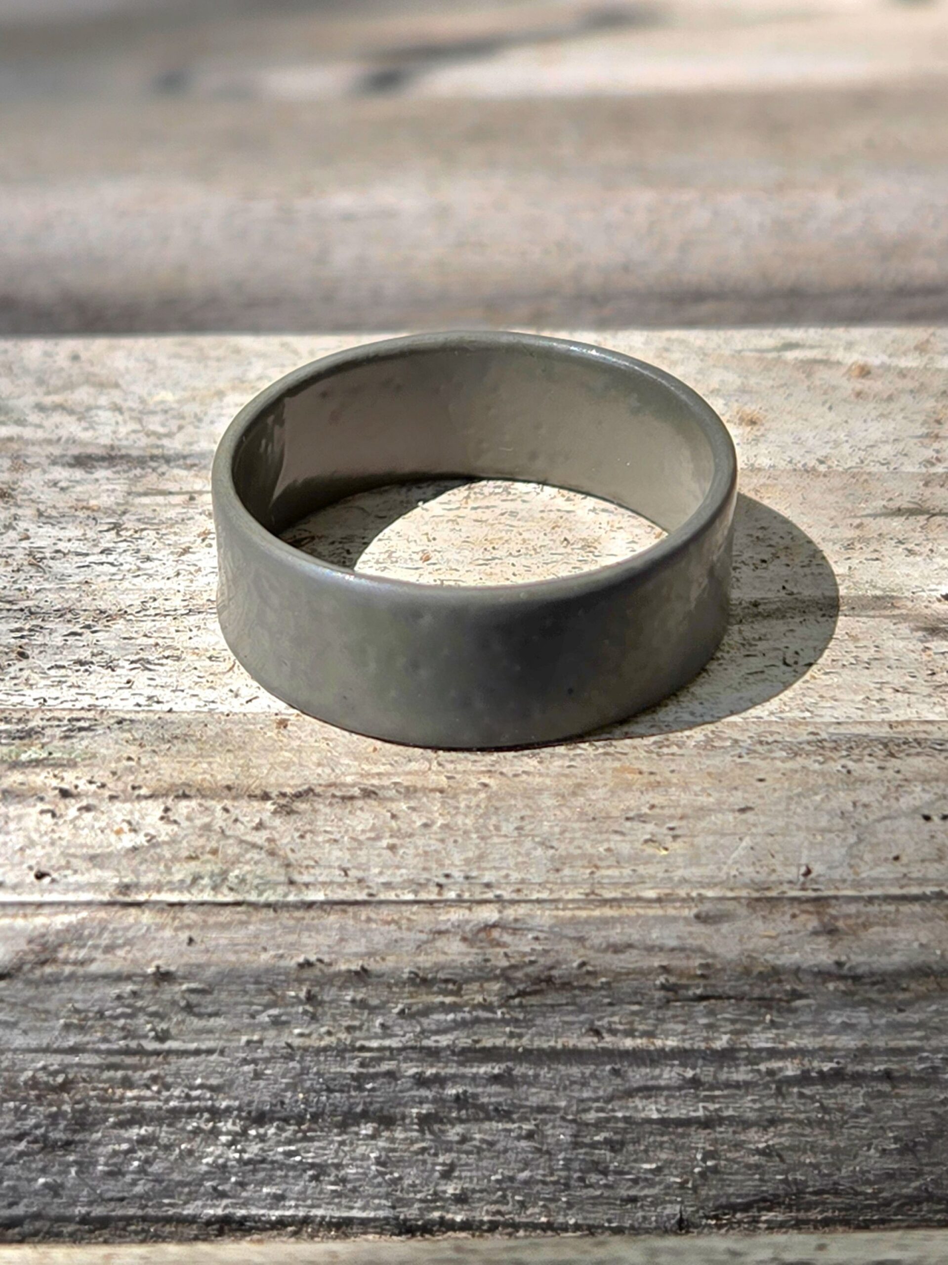 Ceramic Coated Ring in military green on a wooden background