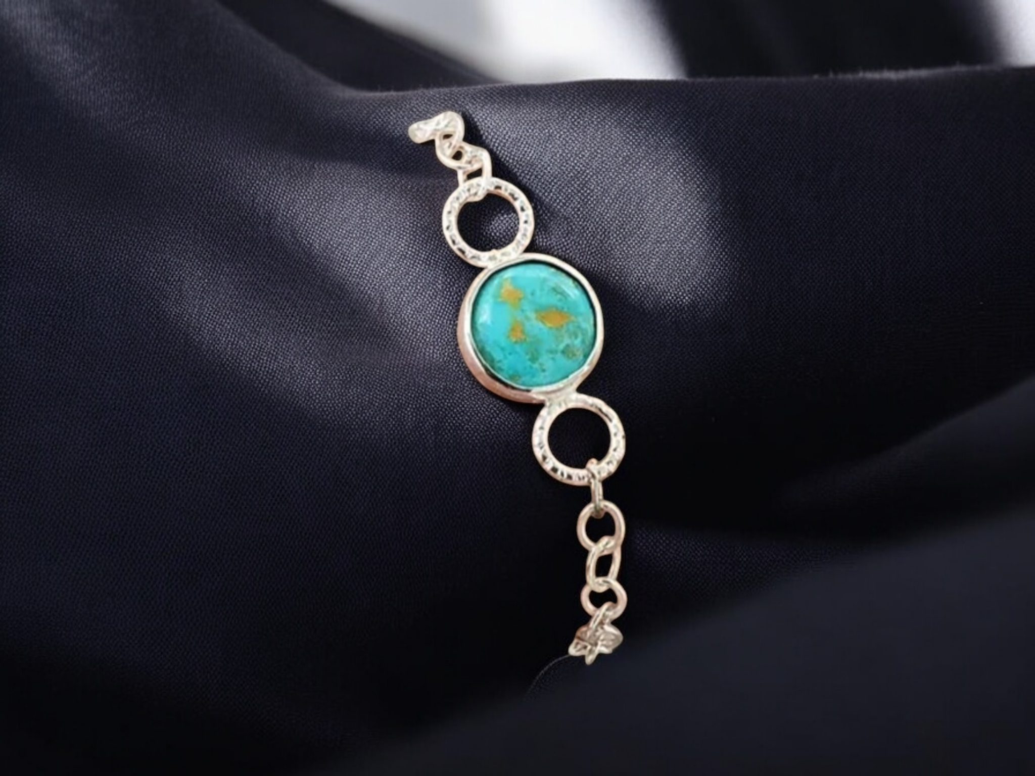 Round Turquoise Cabochon Sterling Silver Chain Bracelet on a black background