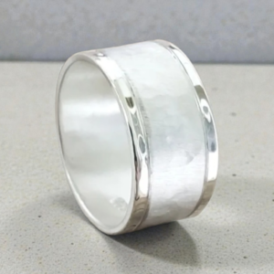 Sterling silver blended texture and finish ring. Polished edges. Satin and hammered middle. Satin inside stamped with .925.