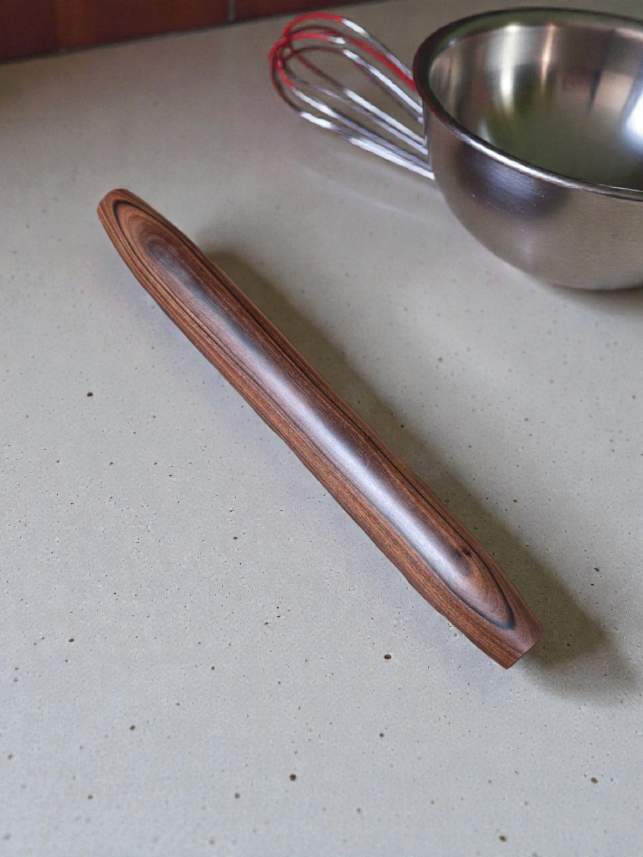 Rosewood French Rolling Pin with tapered ends, shown next to a mixing bowl and whisk