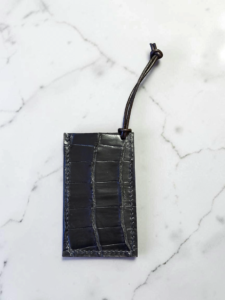 Black alligator leather luggage tag, hand stitched with black waxed thread.