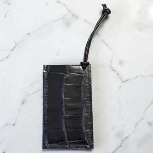 Black alligator leather luggage tag, hand stitched with black waxed thread.